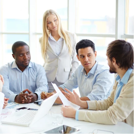 Team discussing governance documents during a business meeting
